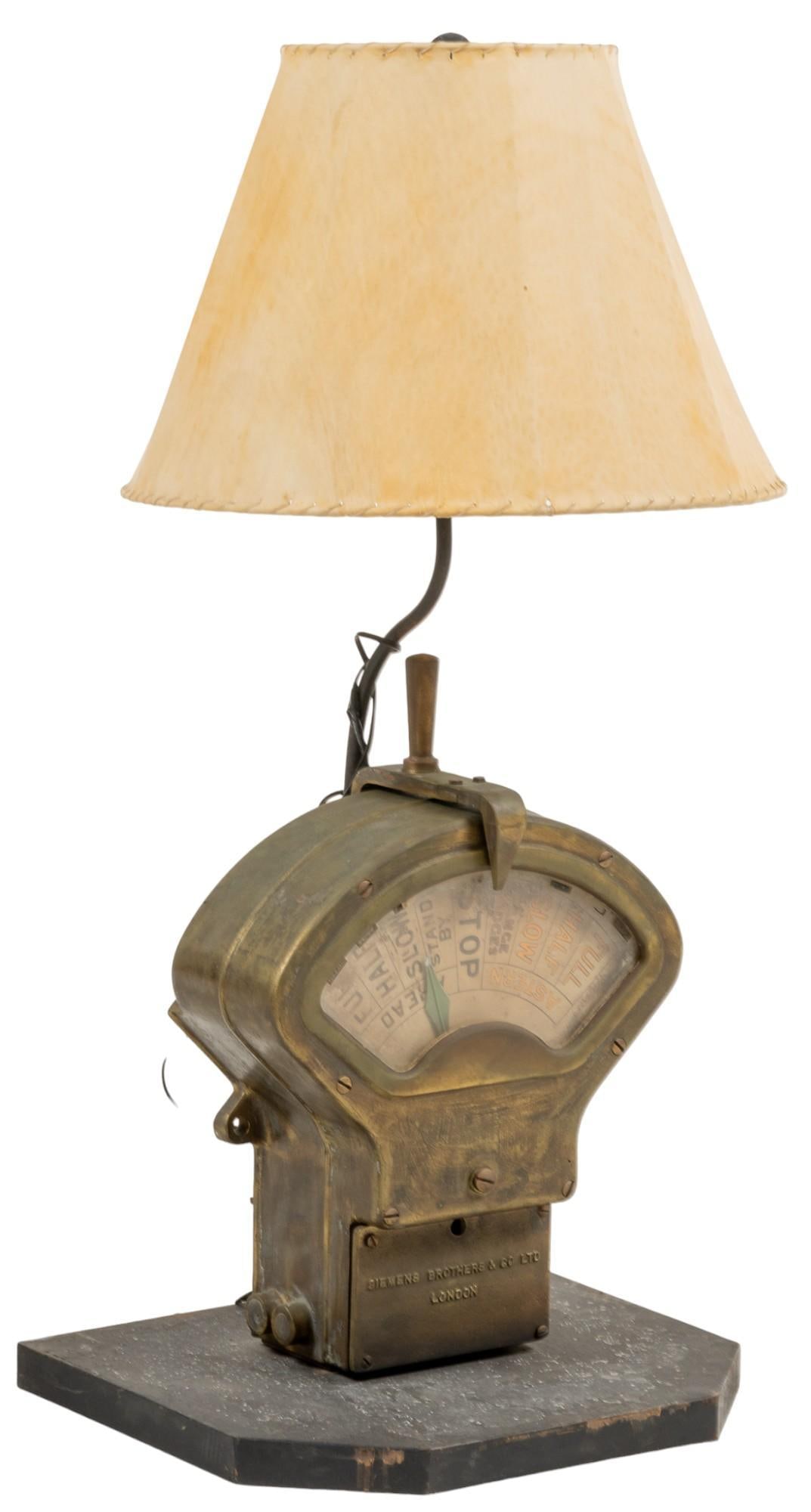 Siemens Bros. Engine Telegraph Lamp: Table lamp featuring a vintage reclaimed Siemens Brothers British engine order telegraph machine, marked, includes animal hide shade with whip stitch border, in working order height 43 in. x width 20.