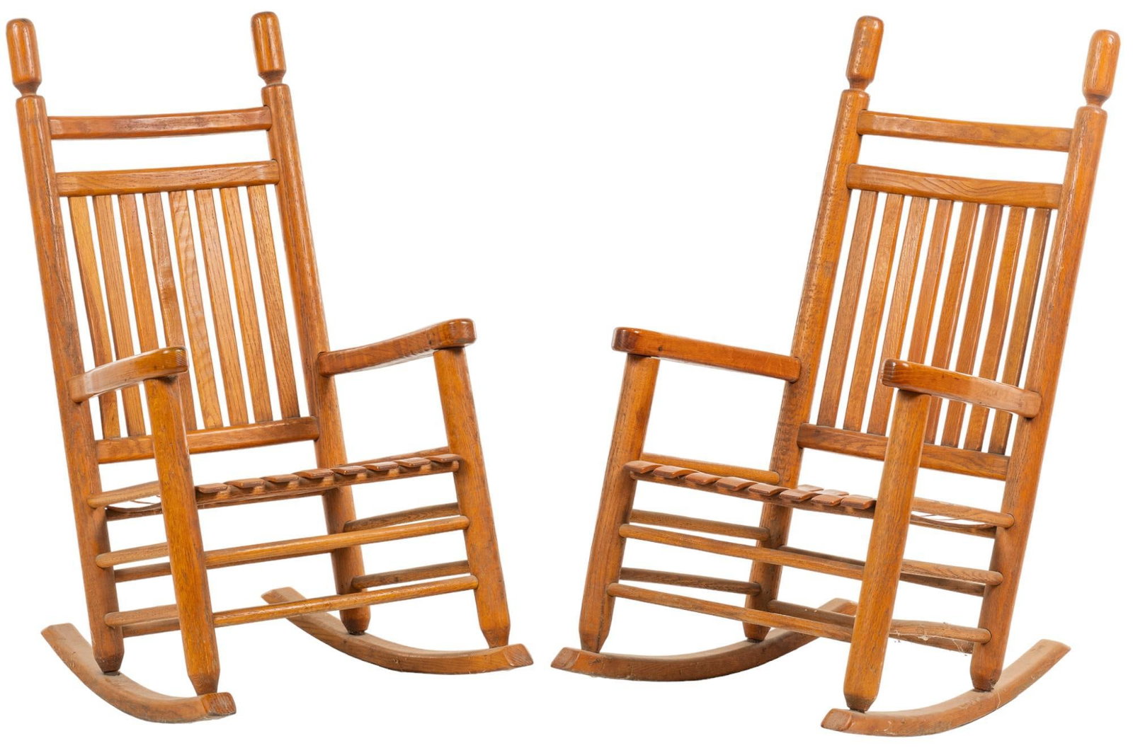 Pair of Farmhouse Rocking Chairs: Pair of farmhouse rocking chairs with slatted back and seat, over double stretcher accents, supported on rockers height 46 in. x width 24 in. x depth 33 in. Provenance: Property from the monumental li