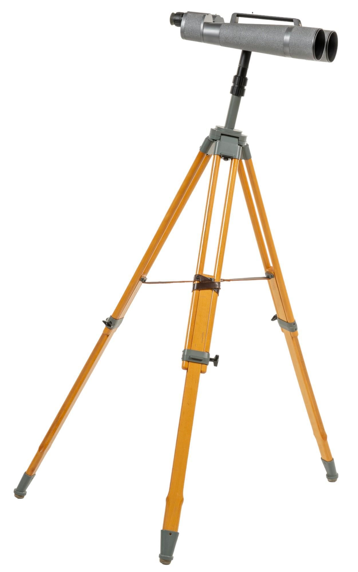 Duetsche Optik Binocular Telescope: Deutsche Optik German brand binocular telescope, supported on adjustable tripod legs height 61 in. x width 39 in. x depth 39 in. Provenance: Property from the monumental lifetime collection of a disti