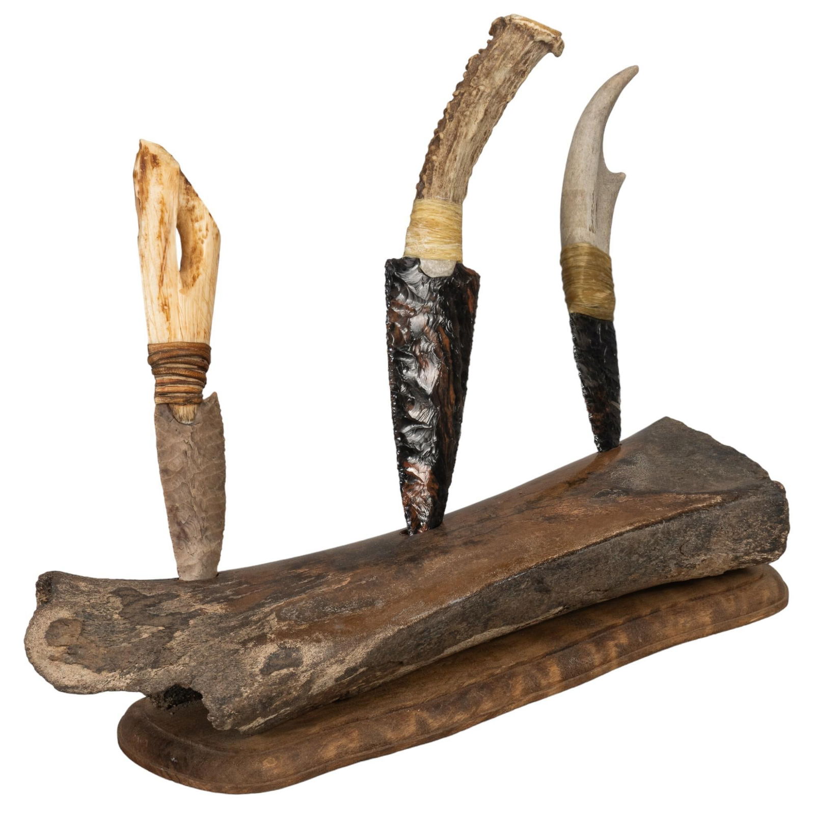 Bone Knife Stand with Three Carved Knives: Fossilized bone knife stand with three carved knives. Materials: (1; smallest) obsidian blade w/ antler handle; (2; largest) red & black obsidian blade w/ antler handle; (3; medium) flint blade w