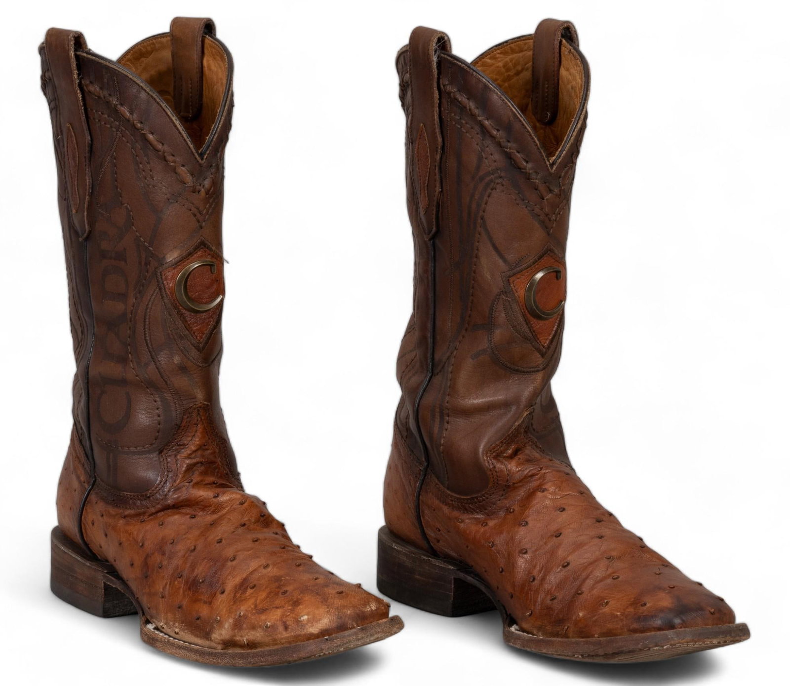 (2) Pairs of Leather Cowboy Boots: Two pairs of men's cowboy boots, includes one pair of Cuadra brand boots of brown cow and exotic leather, with metal C accent, size 9.5, and one pair of Olathe brand boots of black and white leath
