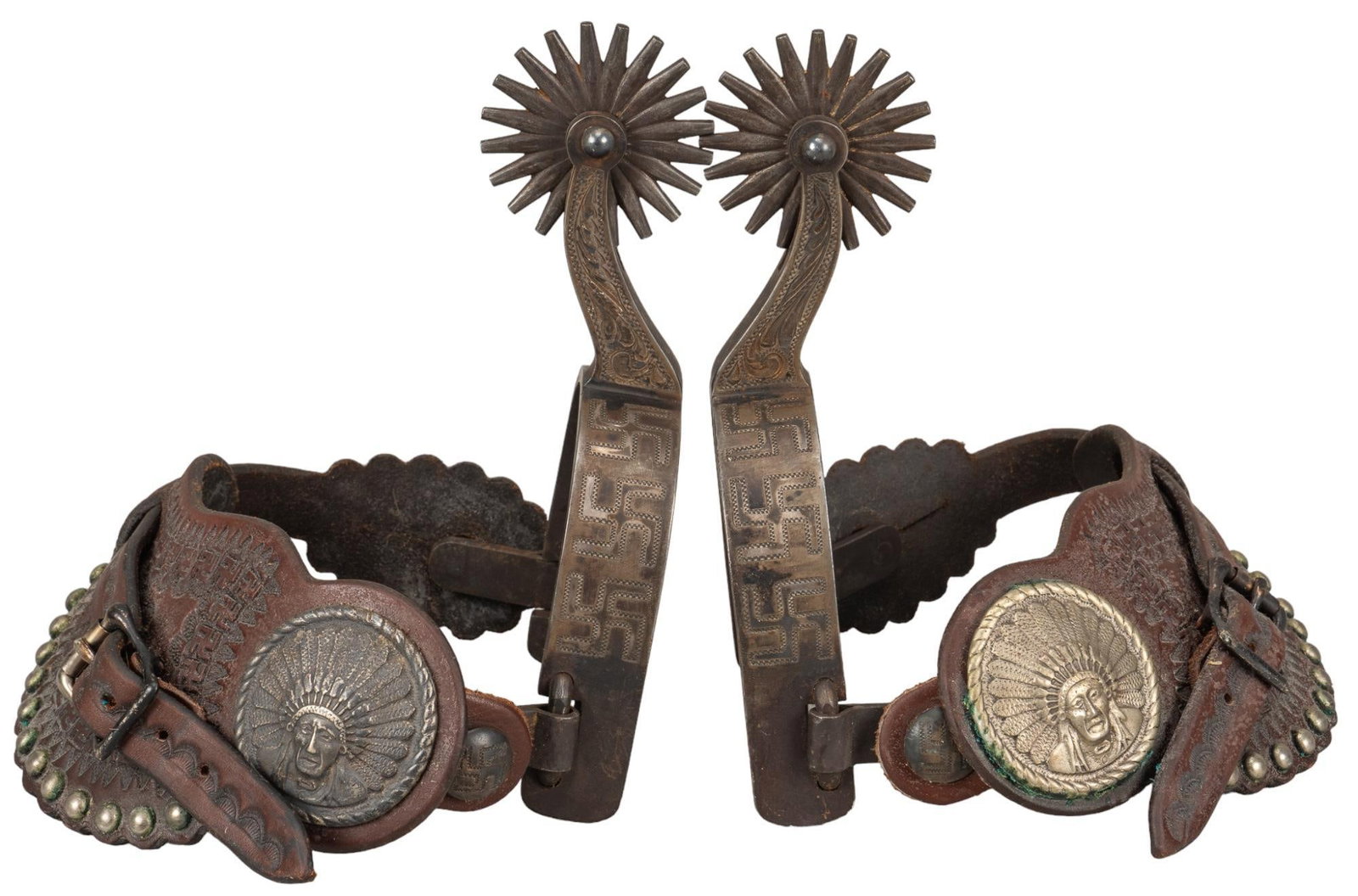 "Rolling Long" Pattern Spurs: "Rolling log" pattern spurs, engraved pattern on heel band and shank, leather is embossed with rolling log pattern, Native American face style feature on leather, marked "67-1134" heig