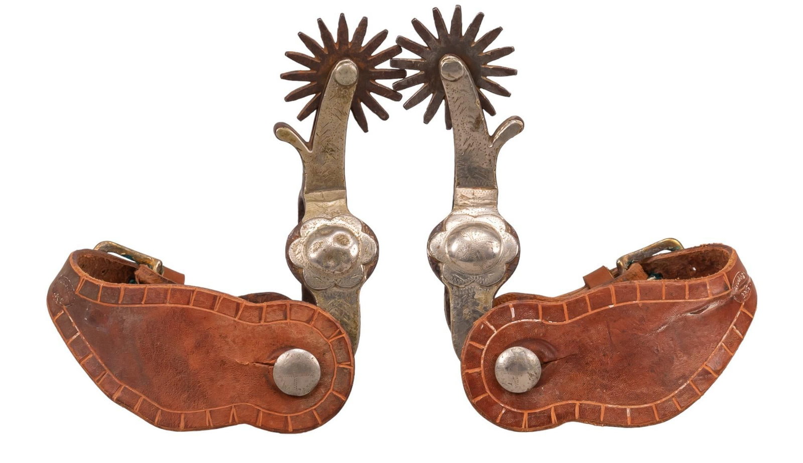 Crockett Silver Mounted Spurs: Crockett blossom pattern silver mounted spurs, plate of silver mounting extending from heel band to shank in blossom pattern, plain brown leather band, Crockett marked heel strap shank length 7 in. x 