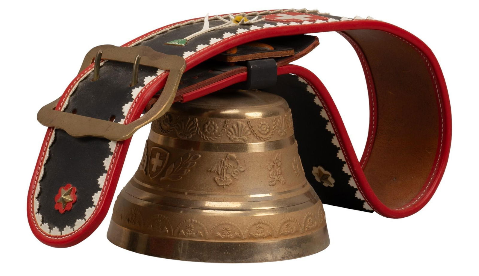 Swiss Style Leather Cowbell: Swiss style leather cowbell, metal bell with cow decorative motifs, leather harness with Swiss flag decoration and geometric leather details, large metal clasp on collar height 18 in. x width 12 in.