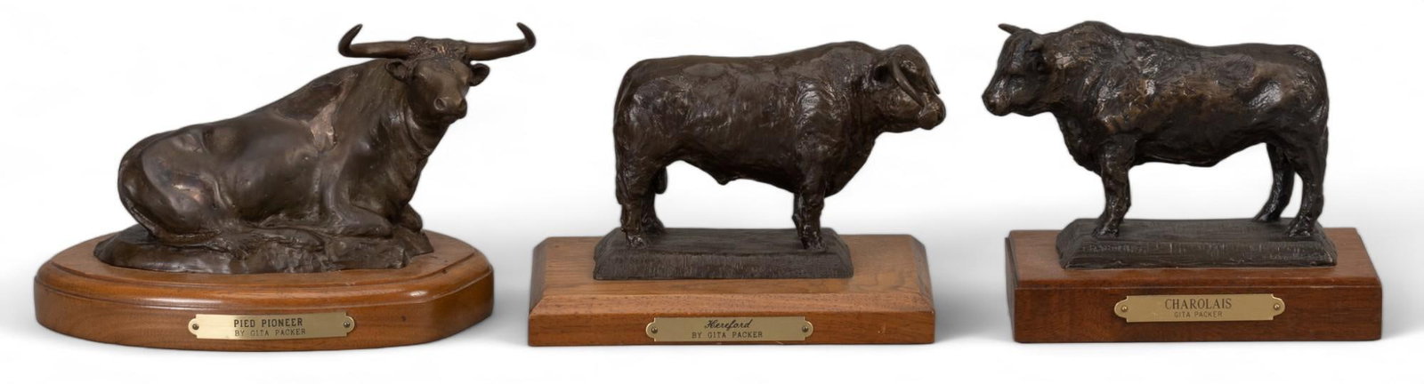 Gita Packer, (3) Cow Bronzes: Julia "Gita" Packer (Fort Worth, Texas, 1922-2005), (3) cow bronzes to include "Charolais" 6/25, "Hereford" 4/25, "Pied Pioneer" with applied brass accents height 5 in.