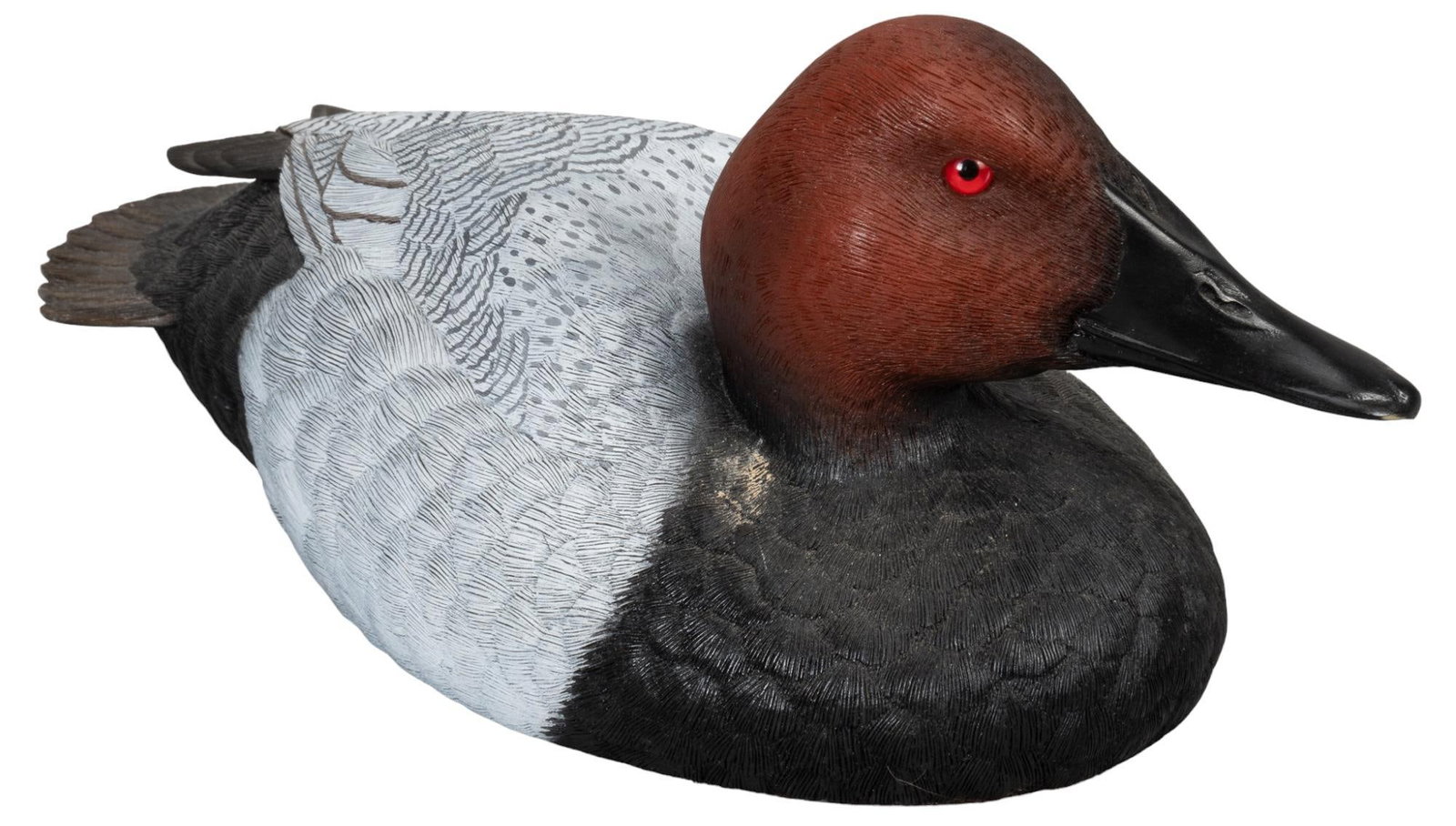 Signed Wooden Decoy: One handcrafted limited edition decoy, by Jules A. Bouillet, marked 1588 / 2500, and signed underneath, circa 1992 height 5.5 in. x width 5.5 in. x depth 12 in. Provenance: Property from the monumenta
