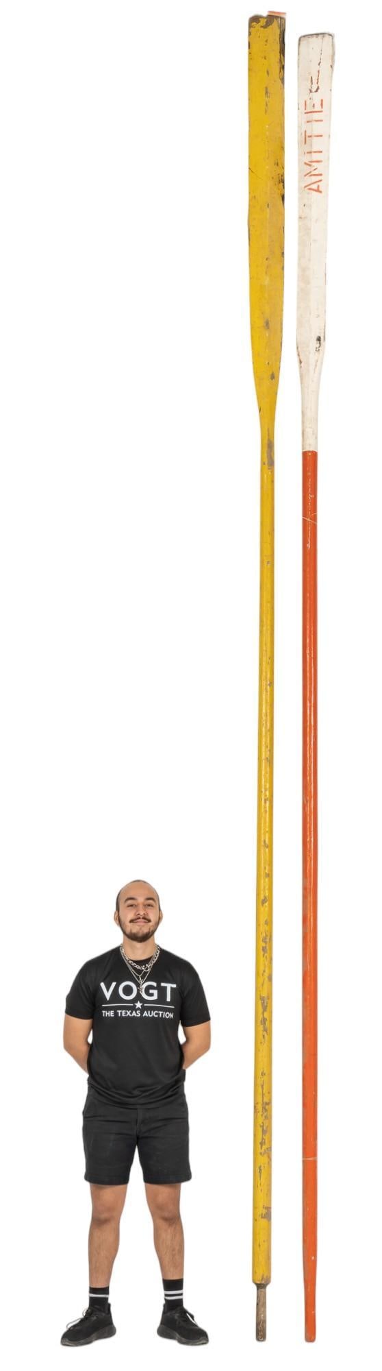 Pair of (2) Wooden Boat Oars: Pair of two large wood boat oars, one yellow, one orange height 192 in. x width 5 in. x depth 2.5 in. Provenance: Property from the monumental lifetime collection of a distinguished Dallas, Texas busi