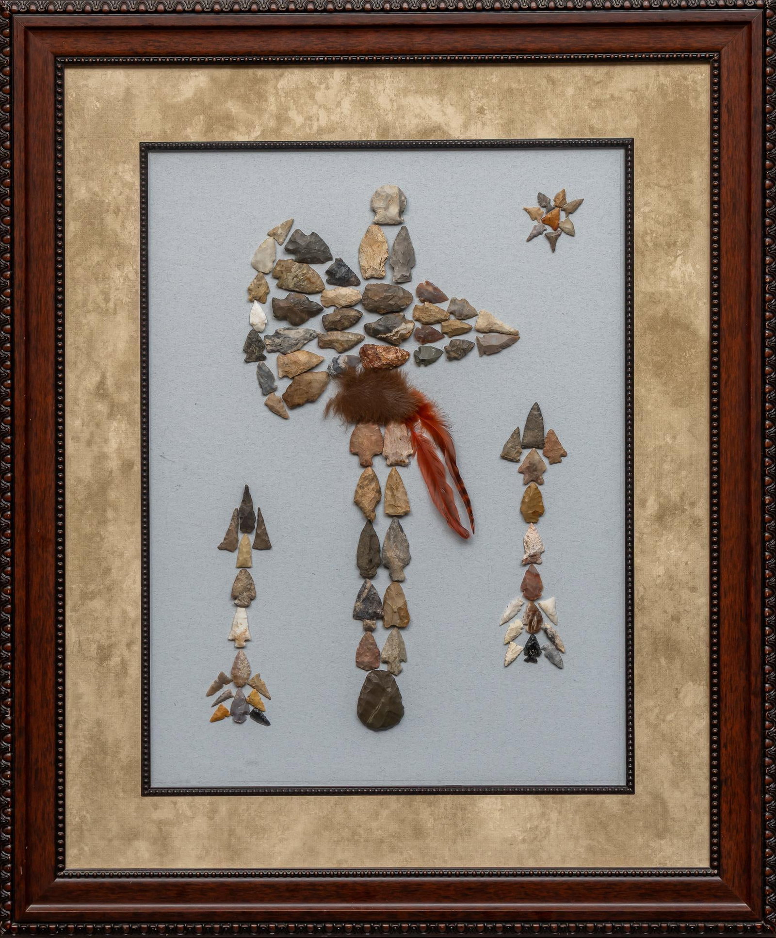 Framed Projectile Point Display: Framed projectile point display, wooden frame with points mounted behind glass, points are placed into a pattern that creates and image of an axe with some feather details, several small details made 