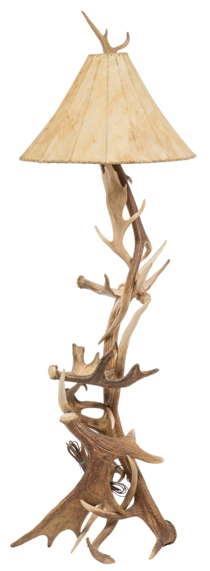 Antler Floor Lamp: Ranch style floor lamp featuring arrangement of deer, elk, and moose antlers, with animal hide shade, with whip stitch edge height 75 in. x width 25 in. x depth 21 in. Provenance: Property from the mo