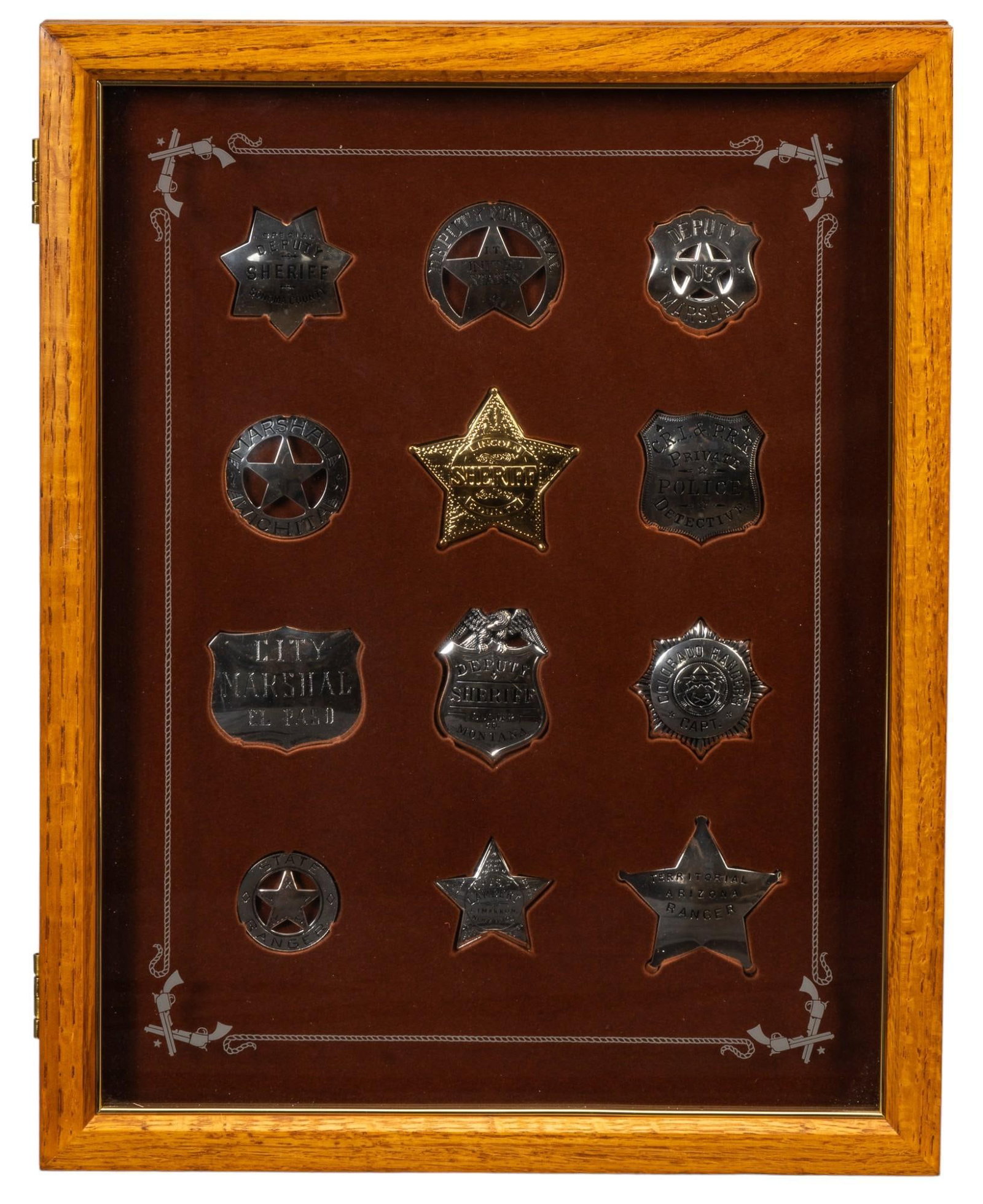 Framed Collection of Vintage Sheriffs Badges: Framed collection of vintage sheriffs badges, includes "Deputy US Marshall", "Territorial Arizona Ranger", and "City Marshall El Paso", twelve total, likley reproduction height