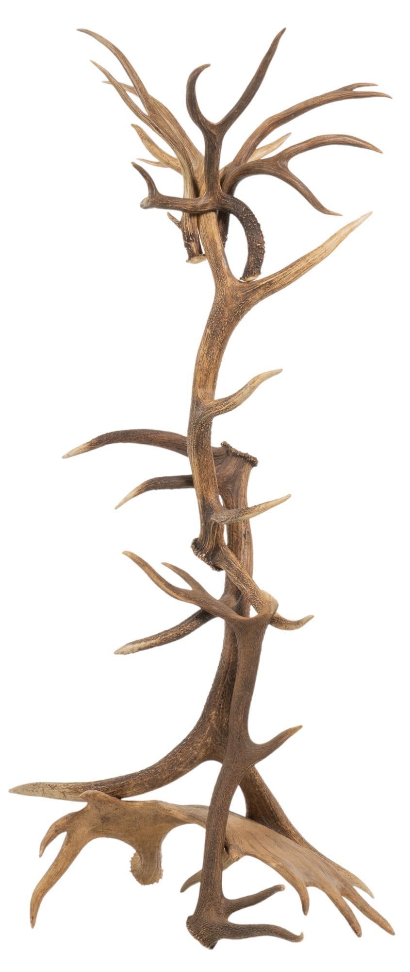 Antler Coat Rack: Ranch style coat rack, featuring arranged assortment of deer, elk, and moose antlers height 73.5 in. x width 35 in. x depth 31 in. Provenance: Property from the monumental lifetime collection of a
