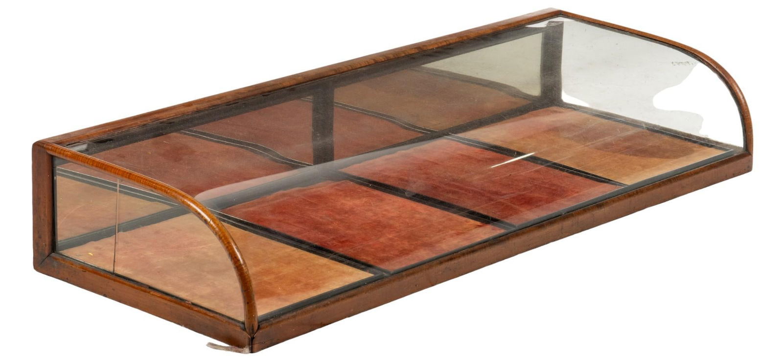 Glass Display Case: Glass display case with wooden frame, curved glass top, fabric lines bottom, mirror on back of case, opens via back of case height 8.5 in. x width 48 in. x depth 18 in. Provenance: Property from the