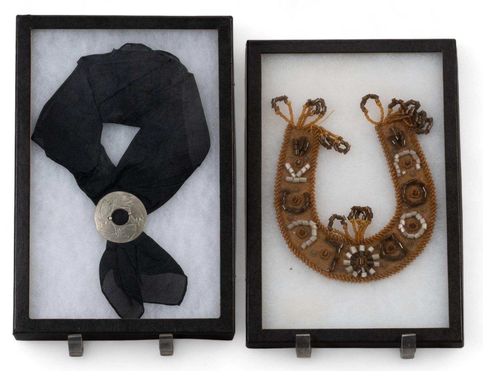 (2) Frames of Southwestern Accents: Pair of shadowbox frame featuring Southwestern style accents, includes neck scarf / ascot with silver-toned metal fastener accent, and one beaded necklace height 2 in. x width 8.5 in. x depth 12.5 in.