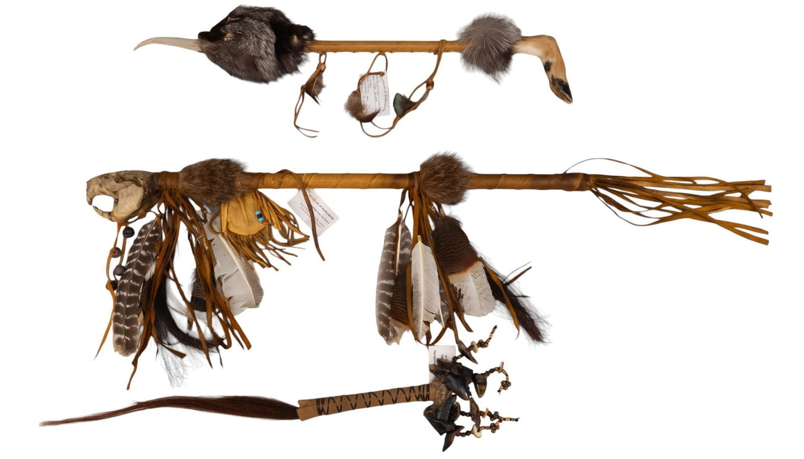 Collection of (3) Native American Shakers: Collection of three Native American shakers, includes deer hoof dance rattle with walrus ivory and horse tail, beaver skull rattle with fox fur, feathers, and deer leather pouch, fox and deer hoof com