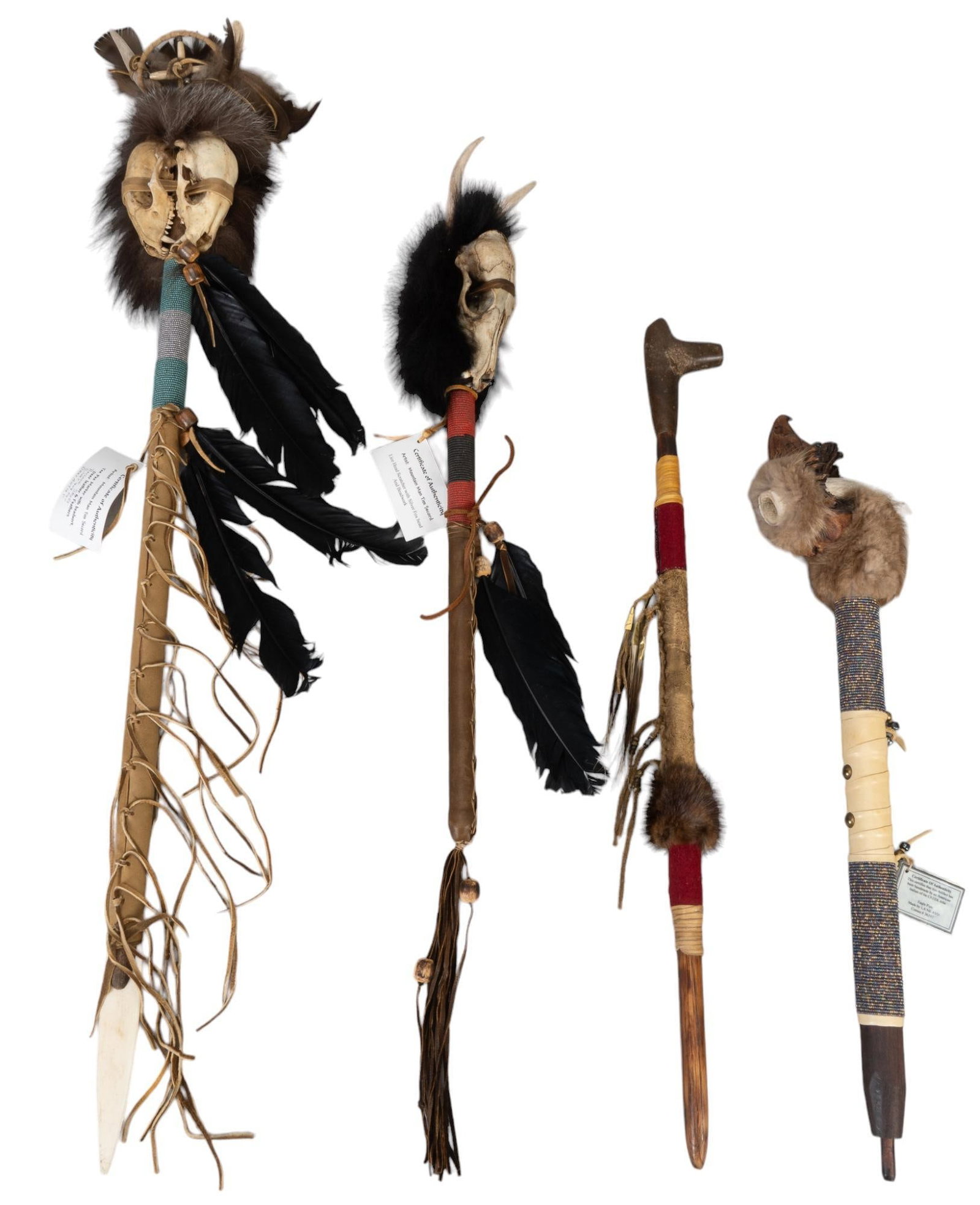 Collection of (4) Native American Objects: Collection of four Native American objects, includes tee pee marker with bead work, deer leather, raccoon skulls, silver fox fur, and feathers, eagle pipe, second pipe, head scratcher with silver fox