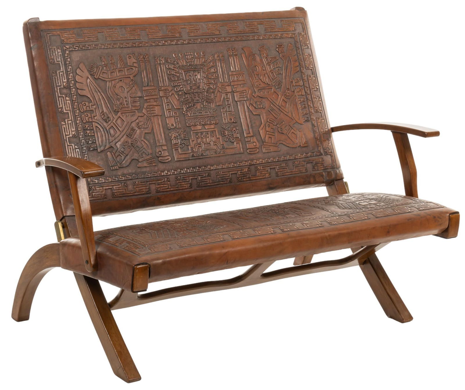 Peruvian Leather Loveseat: Peruvian loveseat featuring tooled traditional motifs, with sloping wooden armrests, supported on sloping wooden legs height 38.5 in. x width 52 in. x depth 32 in. Provenance: Property from a San A
