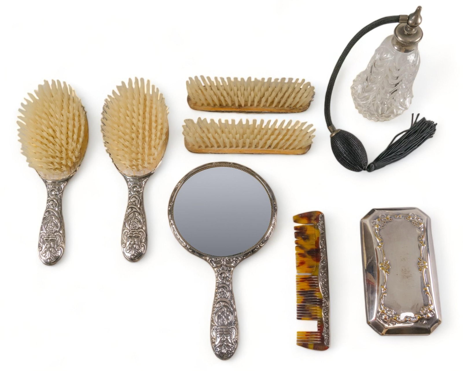Vikki Carr | Antique Sterling Silver Vanity Accessories: Collection of antique sterling silver vanity accessories, includes six (6) piece matching English sterling silver repousse North Wind face set including mirror, four brushes and comb; as well as silve