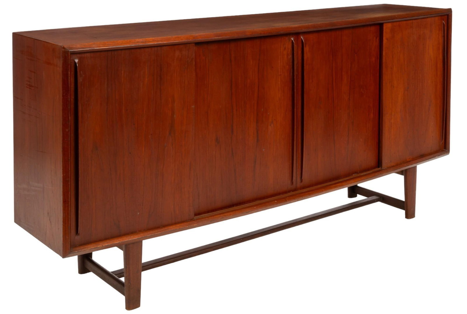 Danish Mid-Century Credenza: Danish mid-century teak credenza featuring two sliding doors opening to three interior spaces, the left space has tied shelves with felt lining, the central space has two shelves, the right space also