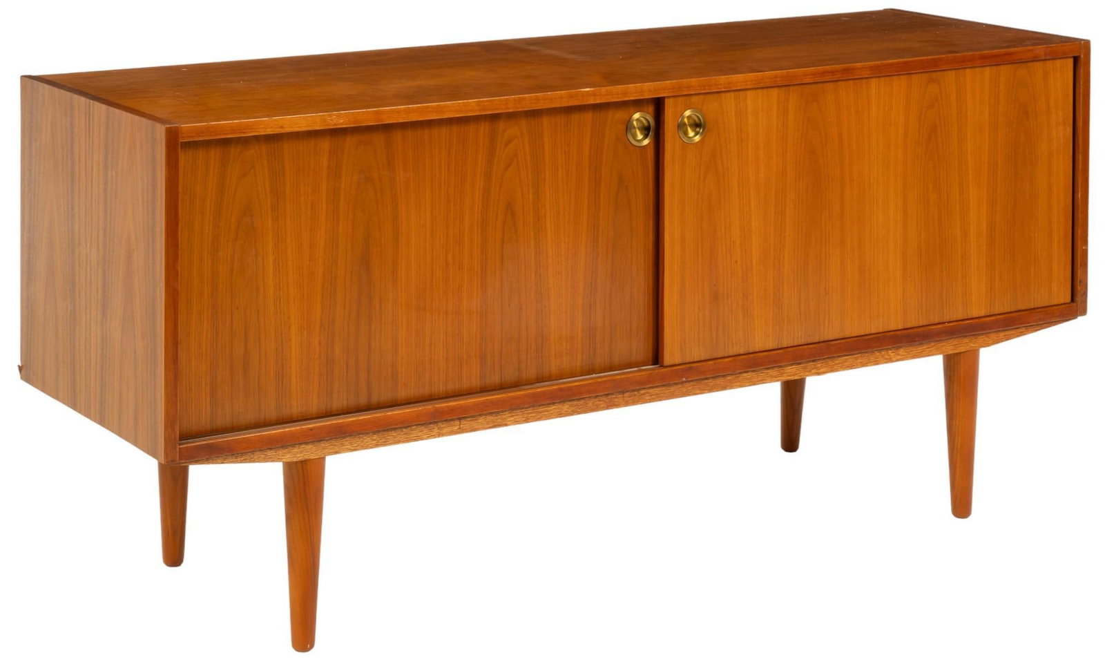 Danish Mid-Century Credenza: Danish mid-century teak credenza featuring gold colored hardware, two sliding doors opening into singular interior cabinet, on pin legs height 27 in. x width 59 in. x depth 18 in. Shipping available f