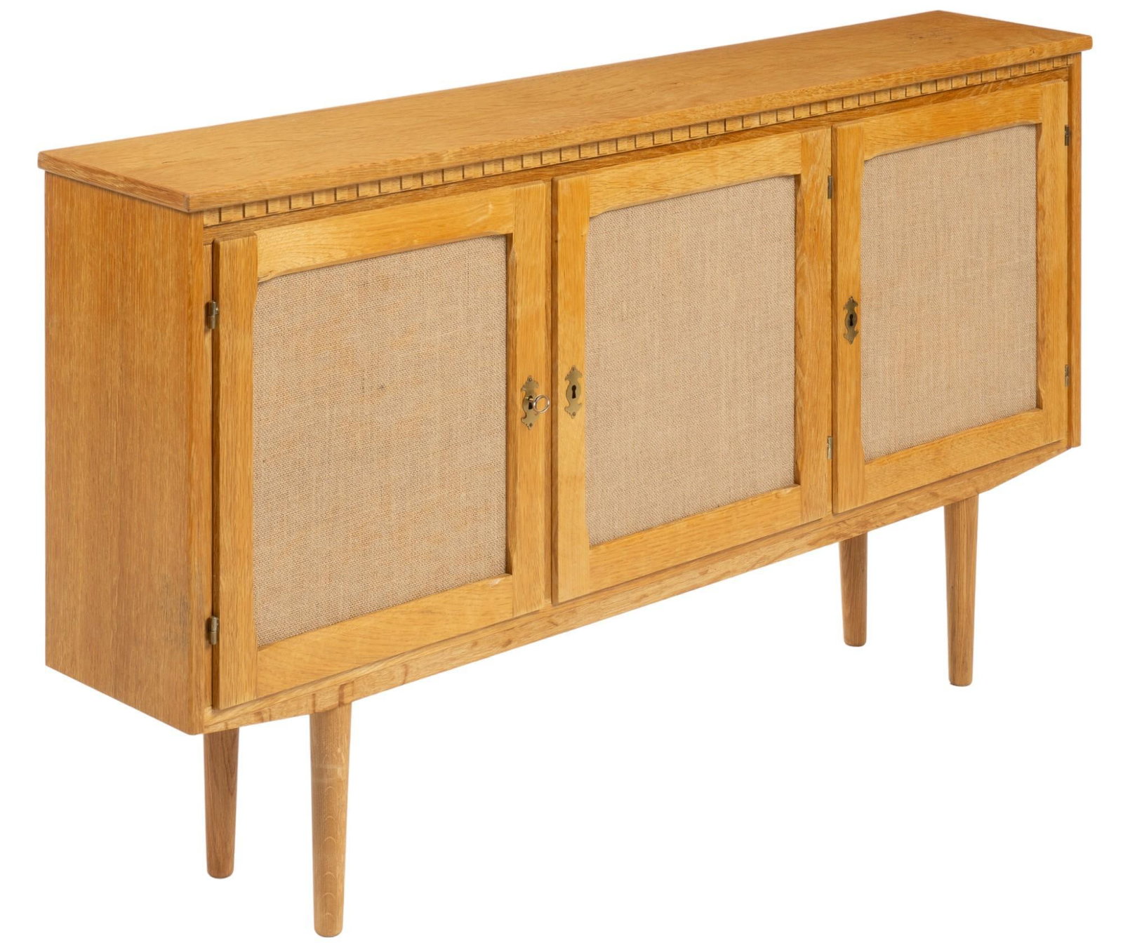 Danish Mid-Century Credenza: Danish mid-century oak credenza featuring three doors opening to two interior shelves, all doors with locking mechanism, on pin legs height 32.5 in. x width 60 in. x depth 10.5 in. Shipping available 