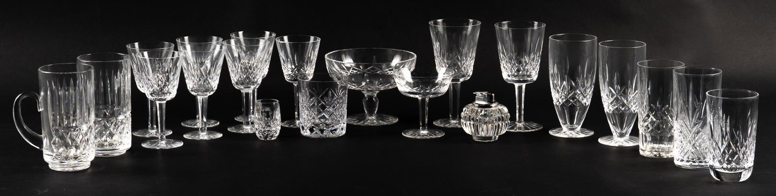 Set of (21) Waterford (USA) Crystal Glasses: Set of twenty-one Waterford (USA) crystal glasses, includes wine glasses, whiskey glasses, small pitchers, lighter, all pieces marked height 7 in. x width 3.5 in. x depth 3.5 in. Shipping available fo