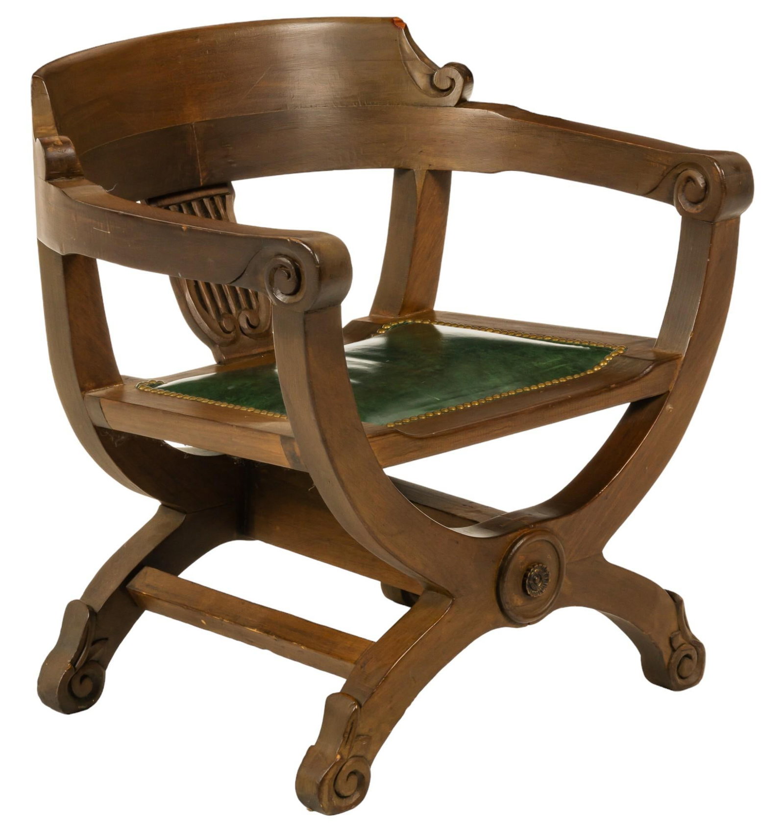 Renaissance Revival Savonarola Chair: Renaissance revival style Savonarola chair, featuring carved scroll details, and green leather seat with metal rivet accents height 28 in. x width 28 in. x depth 23 in. Provenance: Property from the p