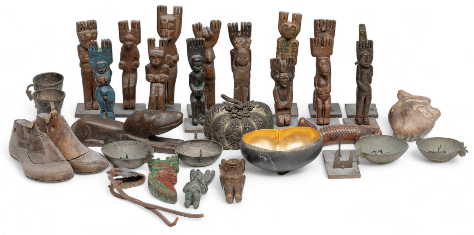 Collection of Folk Art: Mixed collection of folk art, primarily featuring sixteen carved Guatemalan slingshots, also with some metal and carved wood pieces such as scales, figural animal carving, and shoe molds, includes met