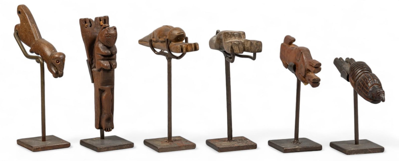 (6) Vintage Guatemalan Slingshots: Collection of six vintage carved wooden Guatemalan slingshots, featuring zoomorphic forms, supported on metal stands height 6.25 in. x width 2 in. x depth 2 in. / largest Shipping available for this l