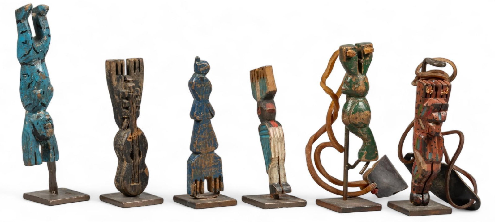 (6) Vintage Guatemalan Slingshots: Collection of six vintage painted and carved wooden figural Guatemalan slingshots, supported on metal stands height 8 in. x width 2.5 in. x depth 2 in. / tallest Shipping available for this lot throug