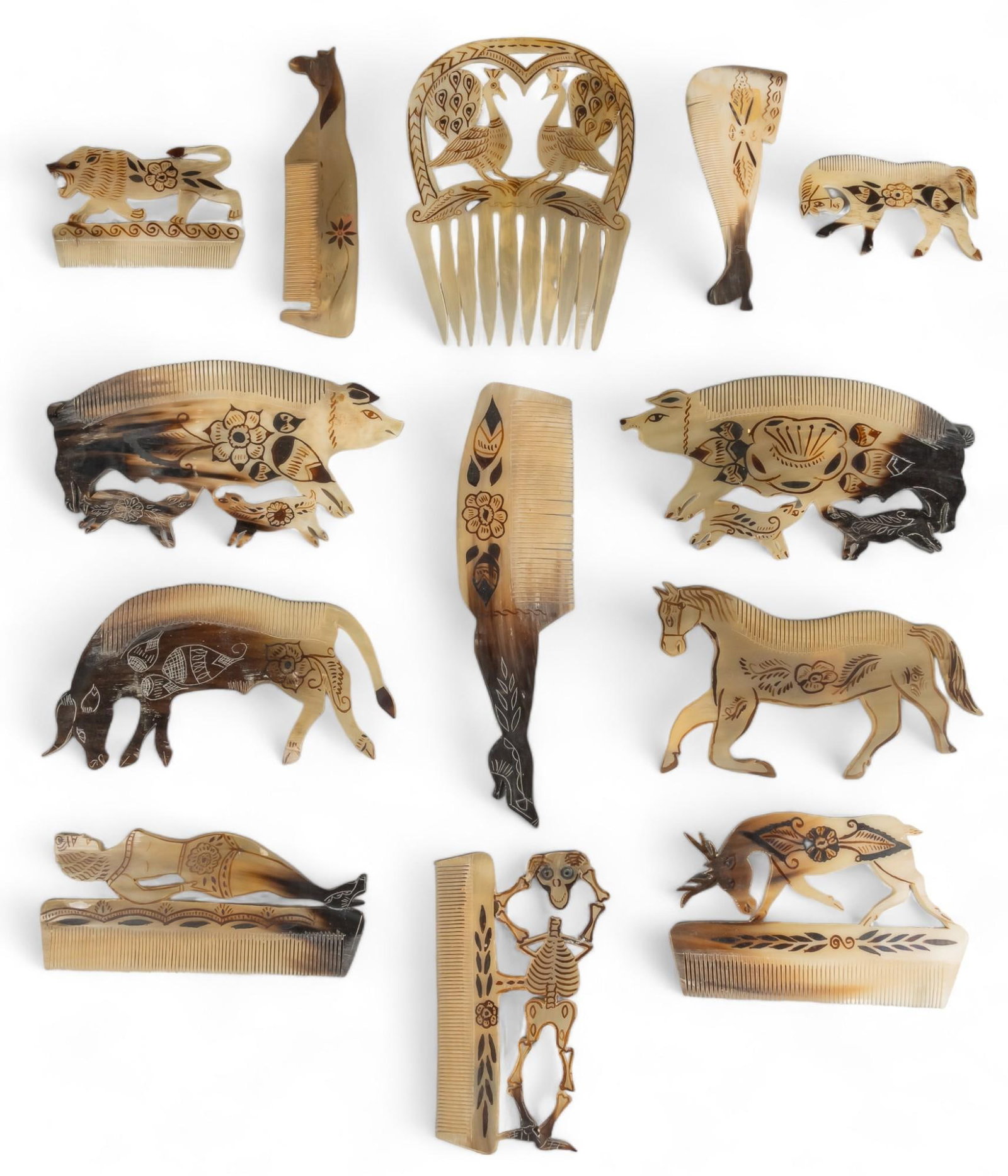 (13) Ox Horn Hair Combs: Collection of thirteen vintage hair combs, of carved ox horn, featuring style originating from San Antonio de la Isla (Mexico), includes examples featuring variety of motifs, including horse, pigs, de