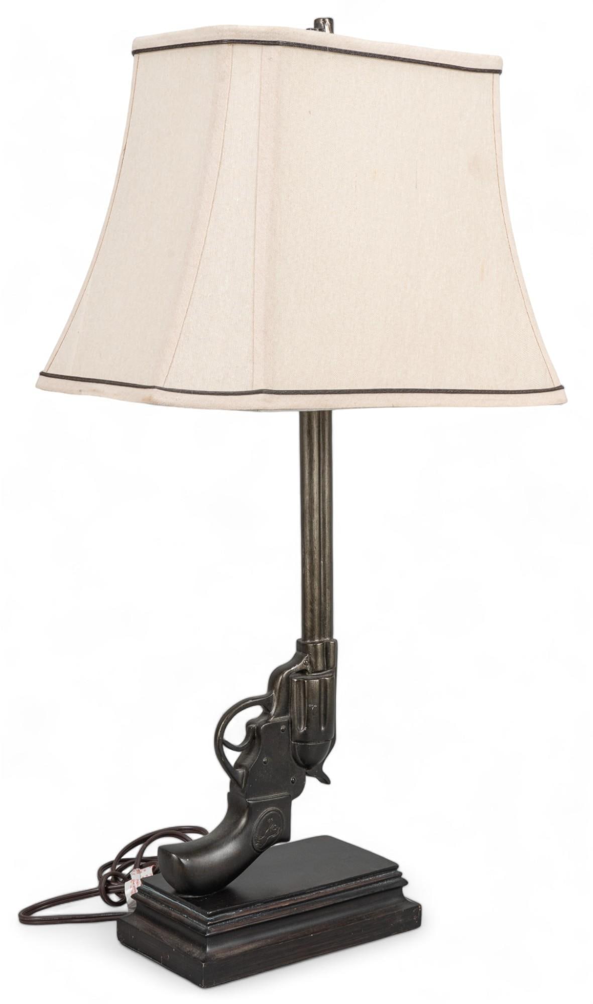 Handgun Lamp: Handgun lamp with linen lamp shade height 29 in. x width 16 in. x depth 11 in. Provenance: Property from the monumental lifetime collection of a distinguished Dallas, Texas business leader and ranch