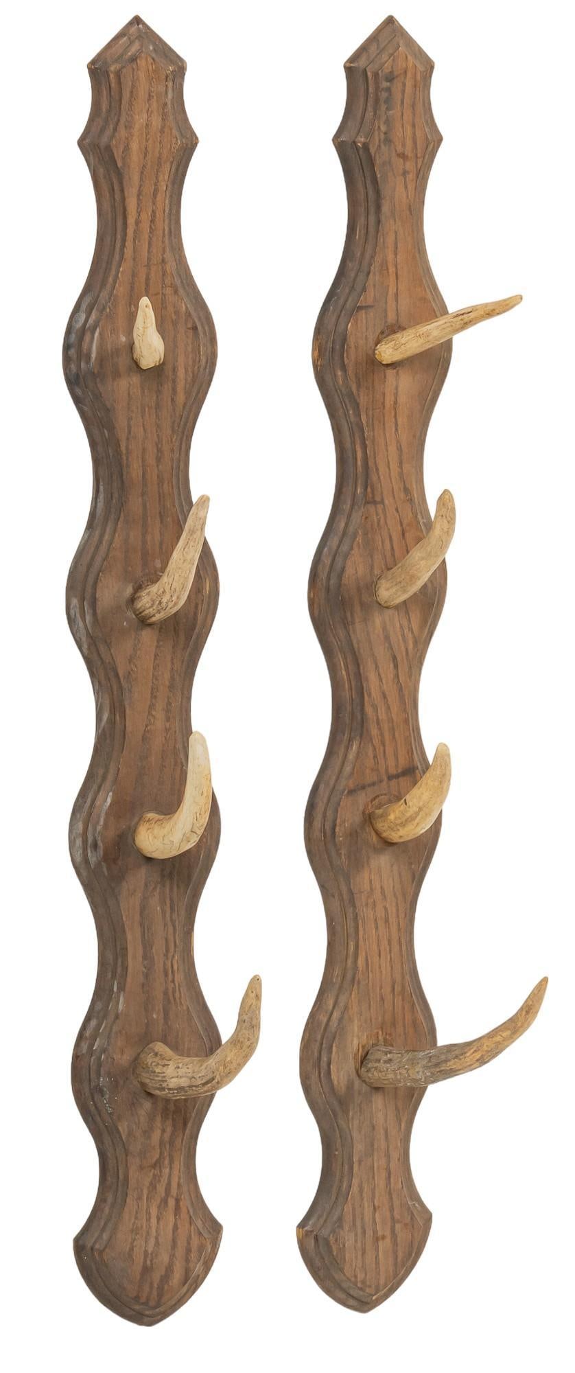 Pair of Antler Racks: Pair of antler racks featuring antler hooks mounted on wood height 23 in. x width 32 in. x depth 1 in. Shipping available for this lot through our partner 4CL; please request a shipping quote at shipp