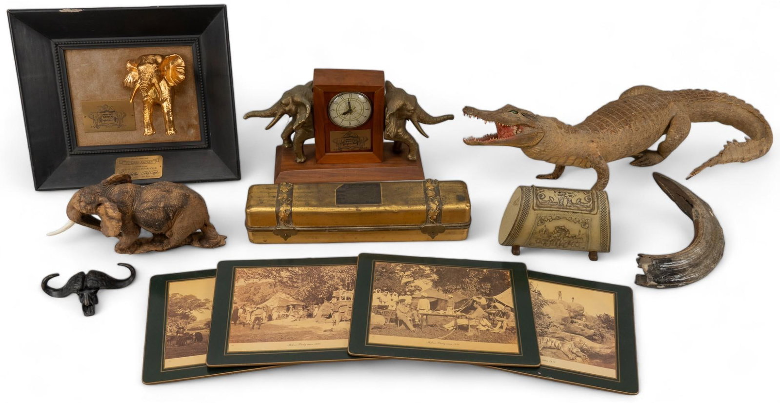 Collection of Keepsakes from the Mount Kenya Hunting Club: Collection of keepsakes from the Mount Kenya Hunting Club, includes two statues with namesake plaques, elephant clock, water buffalo skull statue, faux baby crocodile mount, two pieces of bone, four i