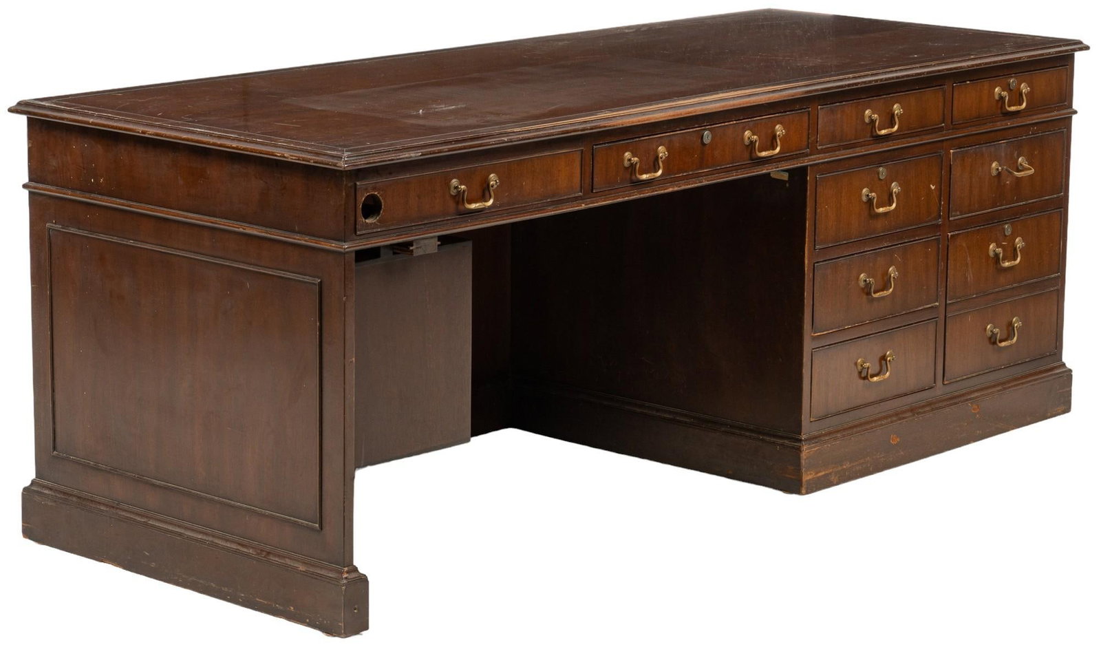 Wooden Desk: Vintage wooden desk featuring dark finish, and nine drawers with metal pulls, and one faux drawer with drilled hole height 31 in. x width 82 in. x depth 32 in. Provenance: Property from the monumental