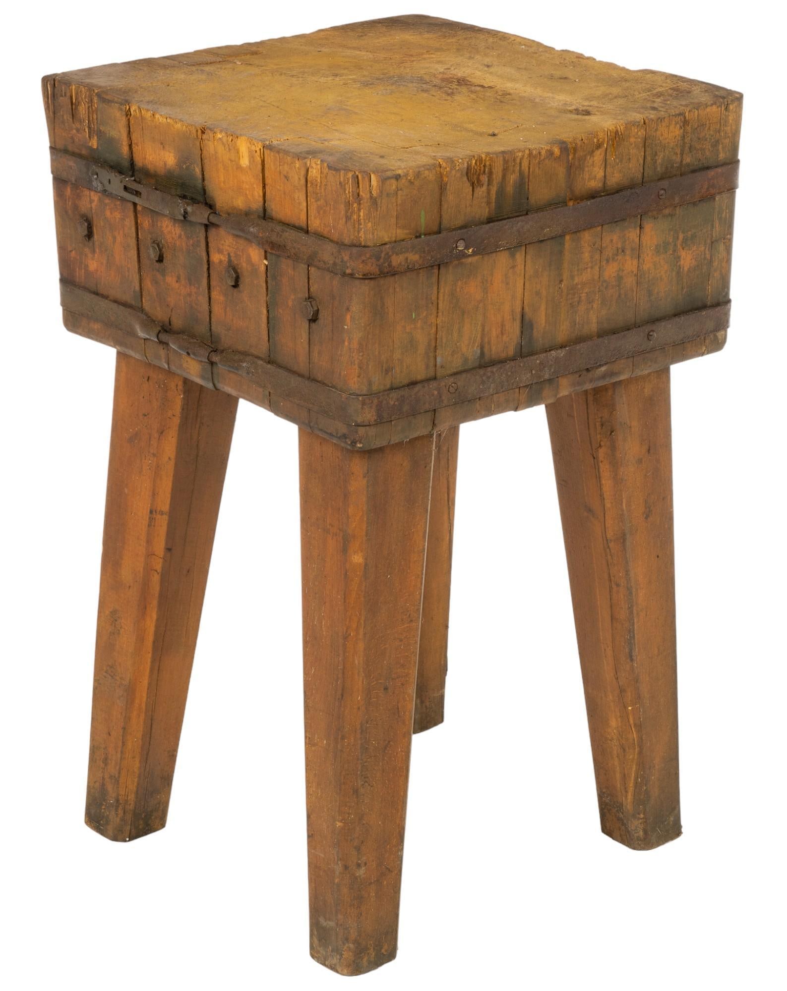 Butchers Block: Butcher block with thick square top with iron banding, supported on four splayed block legs height 33 in. x width 20 in. x depth 20 in. Shipping available for this lot through our partner 4CL; please 