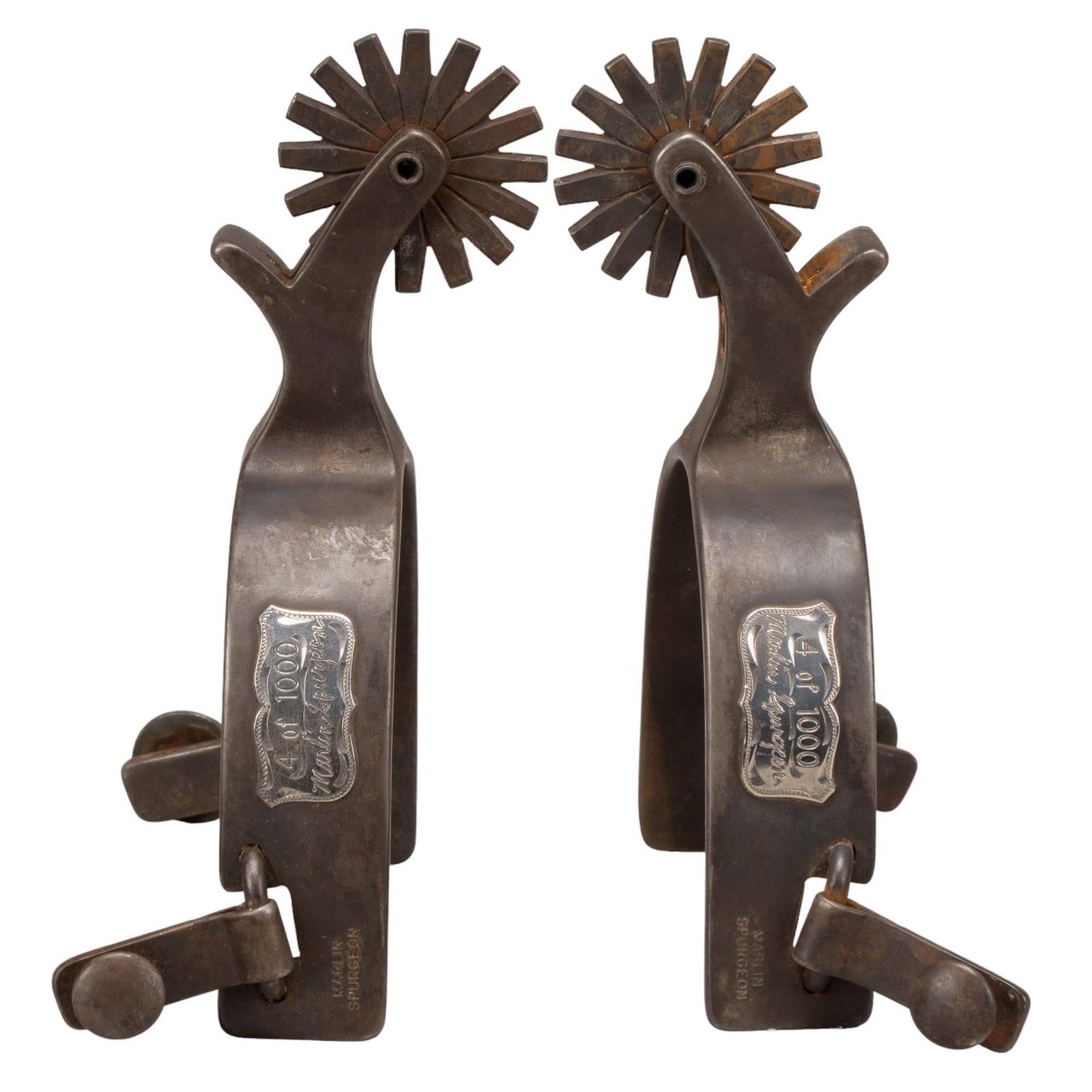 Pair of Marlin Spurgeon Spurs: Pair of Marline Spurgeon "Great American Cattle Drive" silver and steel spurs, dated 1995, marked 4/1000 overall length 2.5 in. x heel width 7 in. x rowel 7 in. Shipping available for this lot