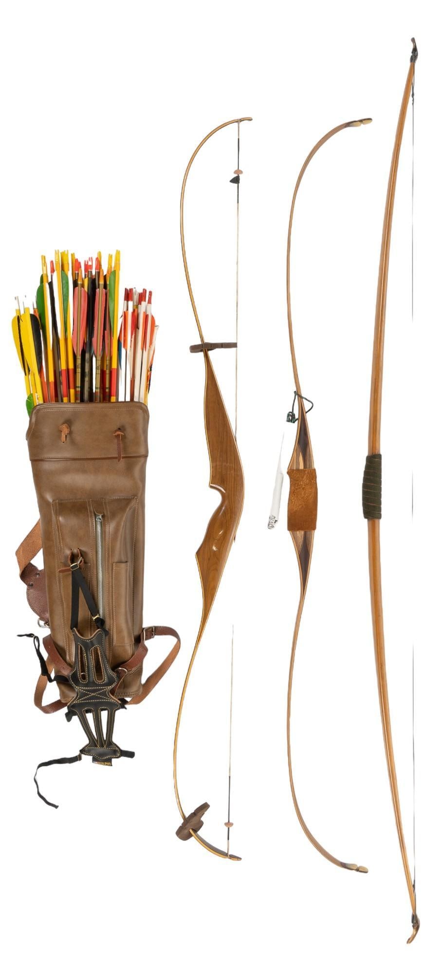 (3) Recurve and Long Bows W/ Quiver and Arrows: (3) recurve and long bows w/ quiver and arrows; Blackhawk and Bighorn height 70 in. x width 5 in. x depth 2 in. / longest Provenance: Property from the monumental lifetime collection of a distingui