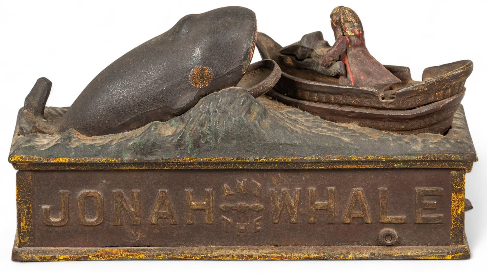 Jonah & The Whale Mechanical Money Bank: Vintage cast iron coin bank featuring "Jonah and the Whale" motif and text, with articulated pieces height 5.5 in. x width 9.5 in. x depth 3.5 in. Shipping available for this lot through our p