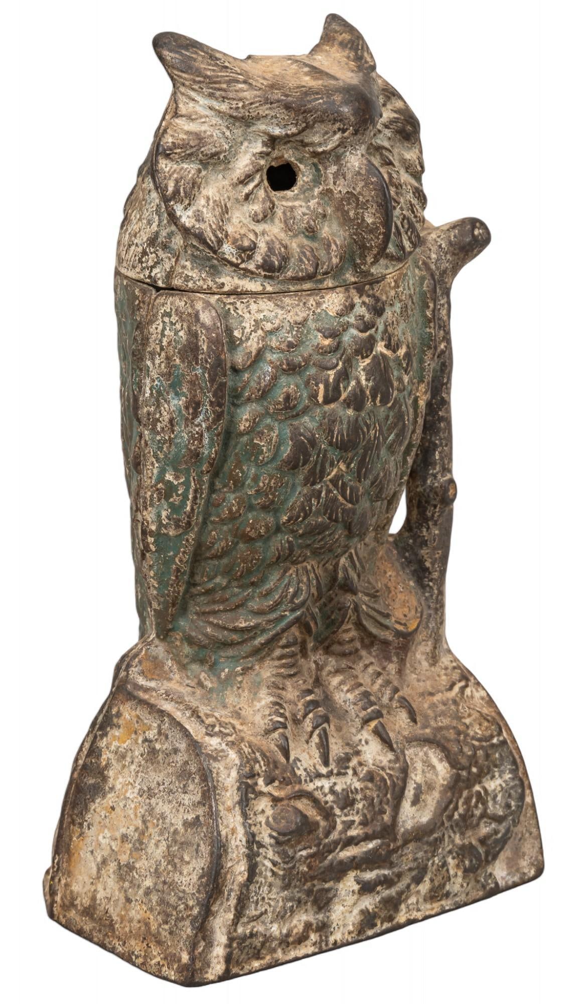 Cast Iron Owl Coin Bank: Articulated cast iron coin bank featuring owl motif with swiveling head height 8 in. x width 4 in. x depth 3 Shipping available for this lot through our partner 4CL; please request a shipping quote at