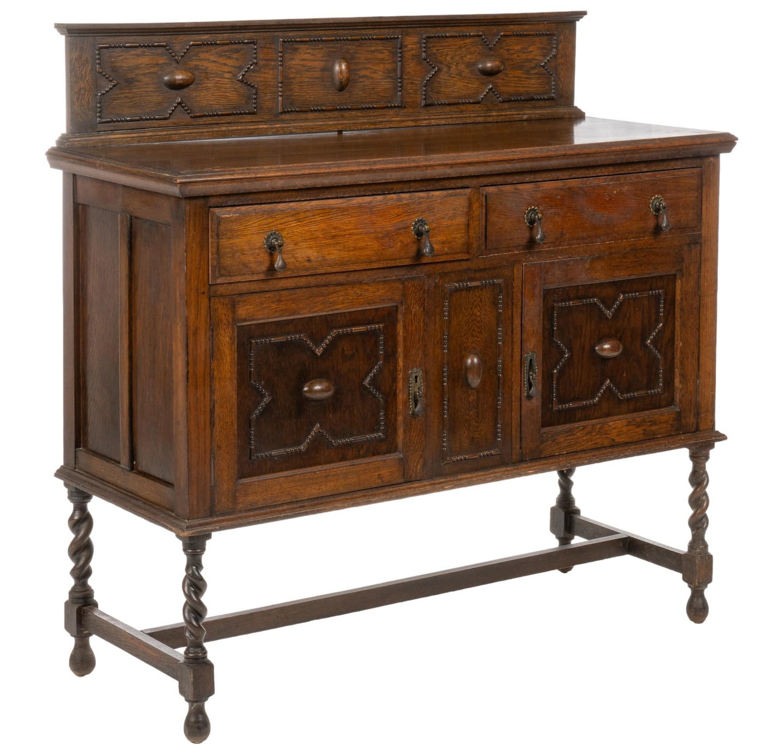 Carved Wood Jacobean Sideboard: Carved wood Jacobean sideboard featuring rectangular crest with geometric designs, two drawers with metal pulls, two lower cabinets with metal pulls opening to two interior shelves, on turned stretche