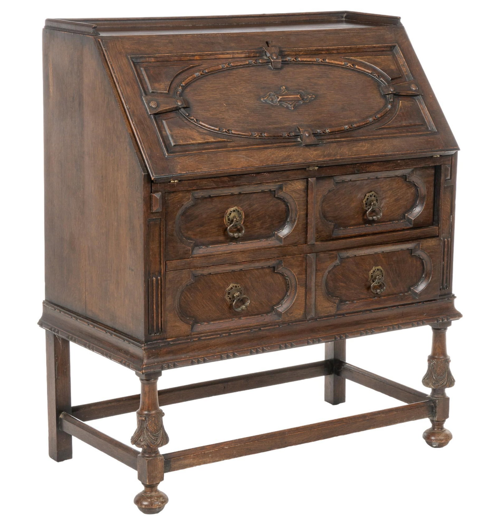 Jacobean Wood Bureau: Jacobean wood bureau featuring carved cabinet door that drops to reveal interior storage with divided compartments, and three drawers, over lower pair of doors with metal ring pulls, over wider bottom