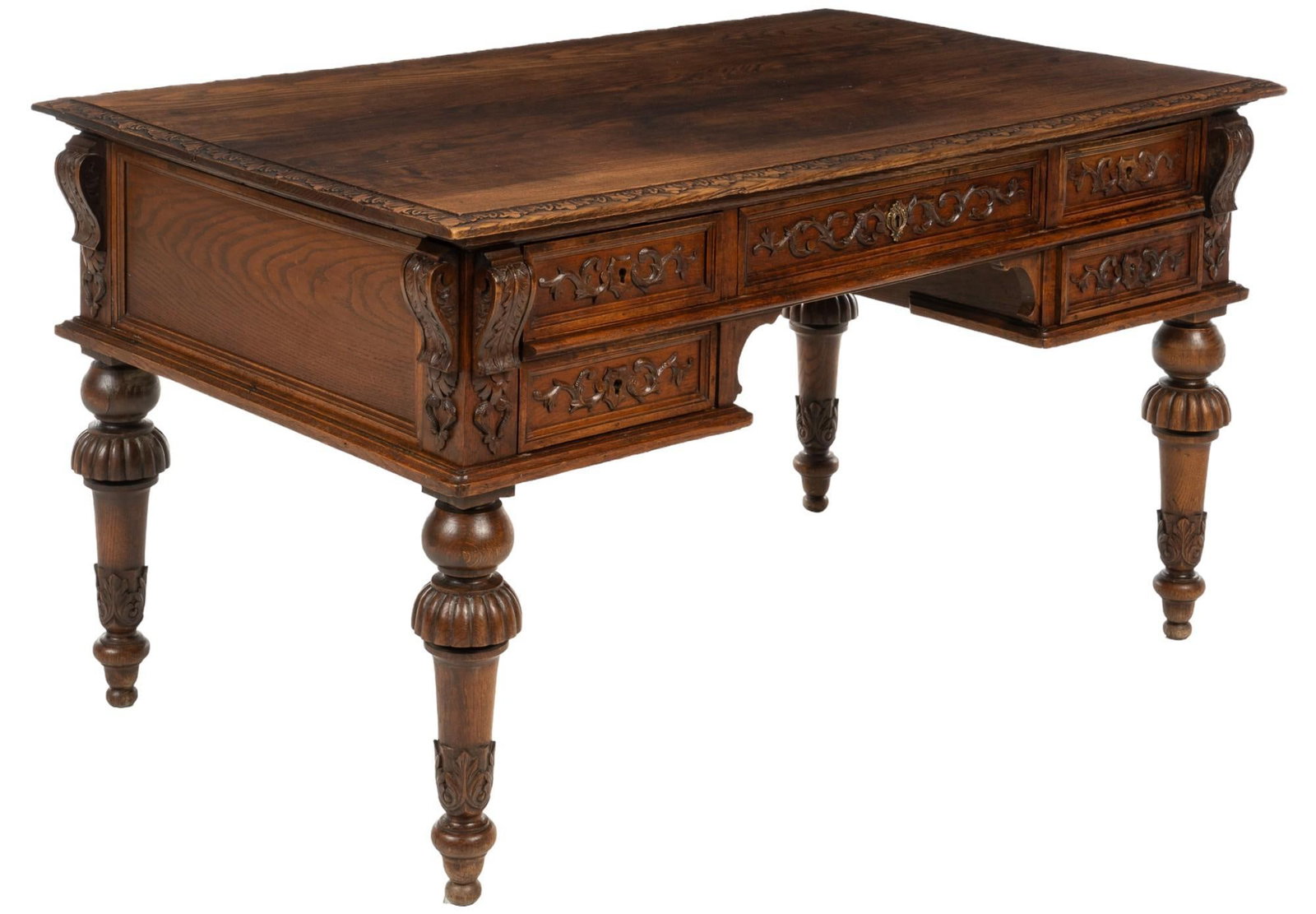 French Desk: French wooden desk featuring oversize top with tooled beveled edge, over four drawers with carved scroll motifs, and carved corbels, supported on turned legs with acanthus leaf motifs height 29.5 in. 