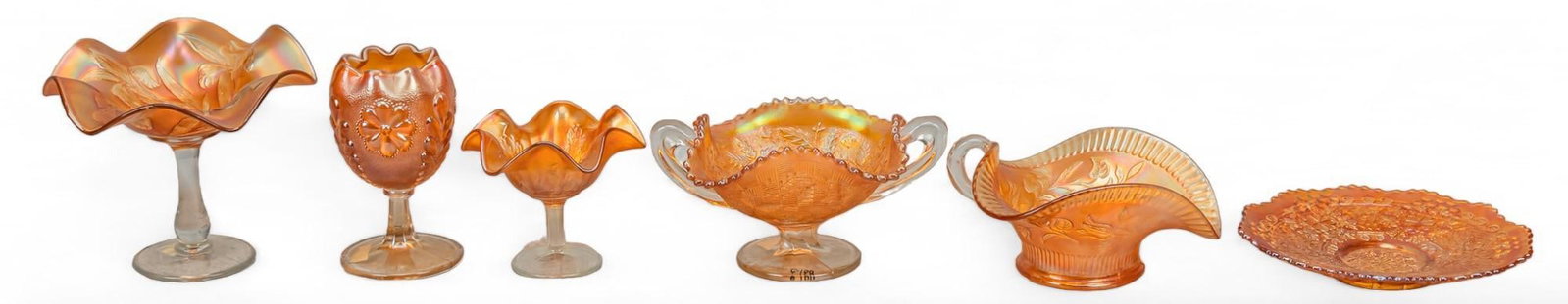 Collection of (6) Marigold Carnival Glassware: Collection of six iridescent marigold carnival glassware with floral motifs, includes two Fenton (West Virginia, USA) ruffled comports, one with iris and one with holly motif, Northwood (West Virginia