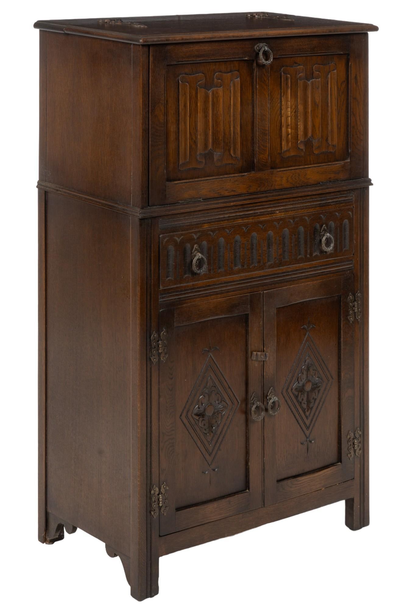 English Linenfold Cocktail Cabinet: English linenfold cocktail cabinet featuring top level door opening to mirrored cabinet and lighting features, central drawer with metal pulls, lower level two door cabinet with two interior shelves, 