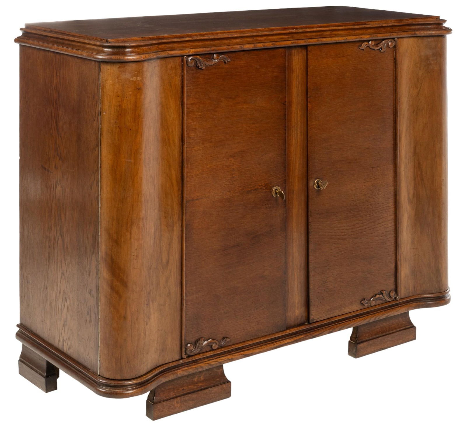Art Deco Wood Cabinet: Art Deco wood cabinet featuring two curved wood doors opening to interior storage space with three shelves, with metal pulls and carved wood accents, on carved block feet height 40 in. x width 51 in