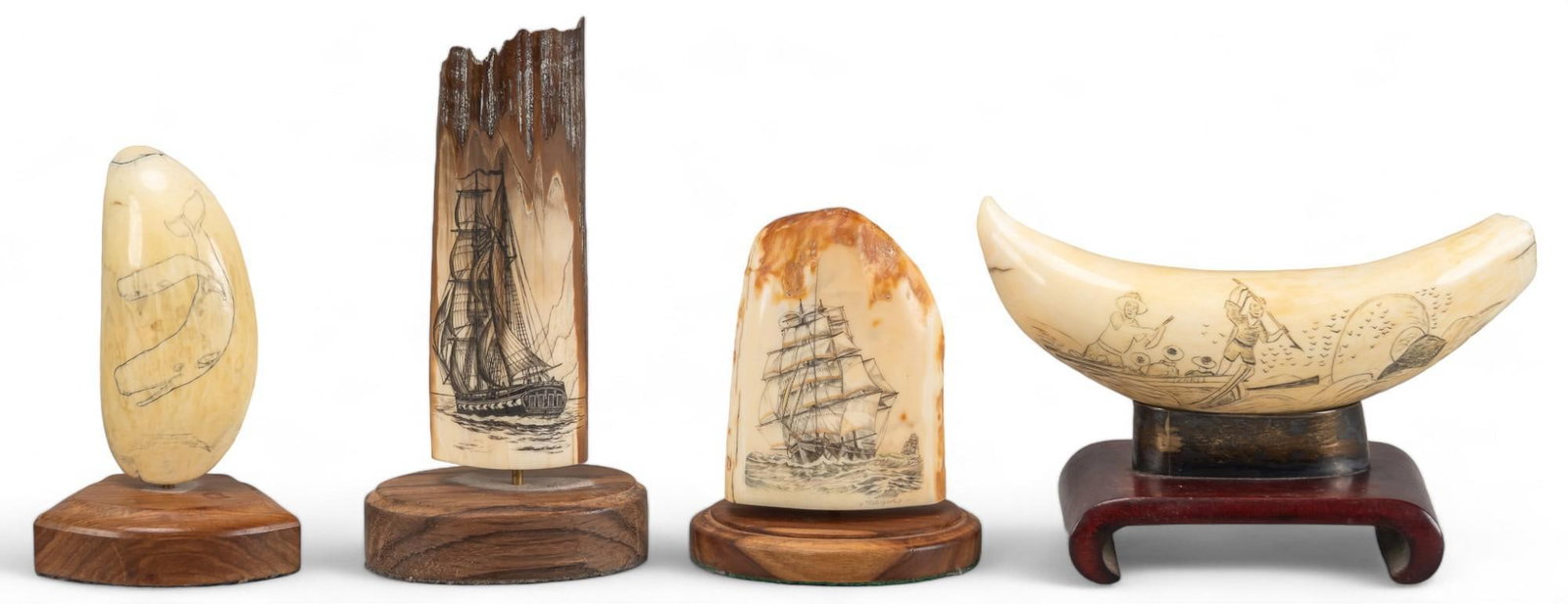 Set of (4) Scrimshaw Bones: Set of four scrimshaw bones including three bones decorated with ships and one bone with whale, all mounted on wood bases height 6 in. x width 3 in. x depth 2 in. / largest Shipping available for this