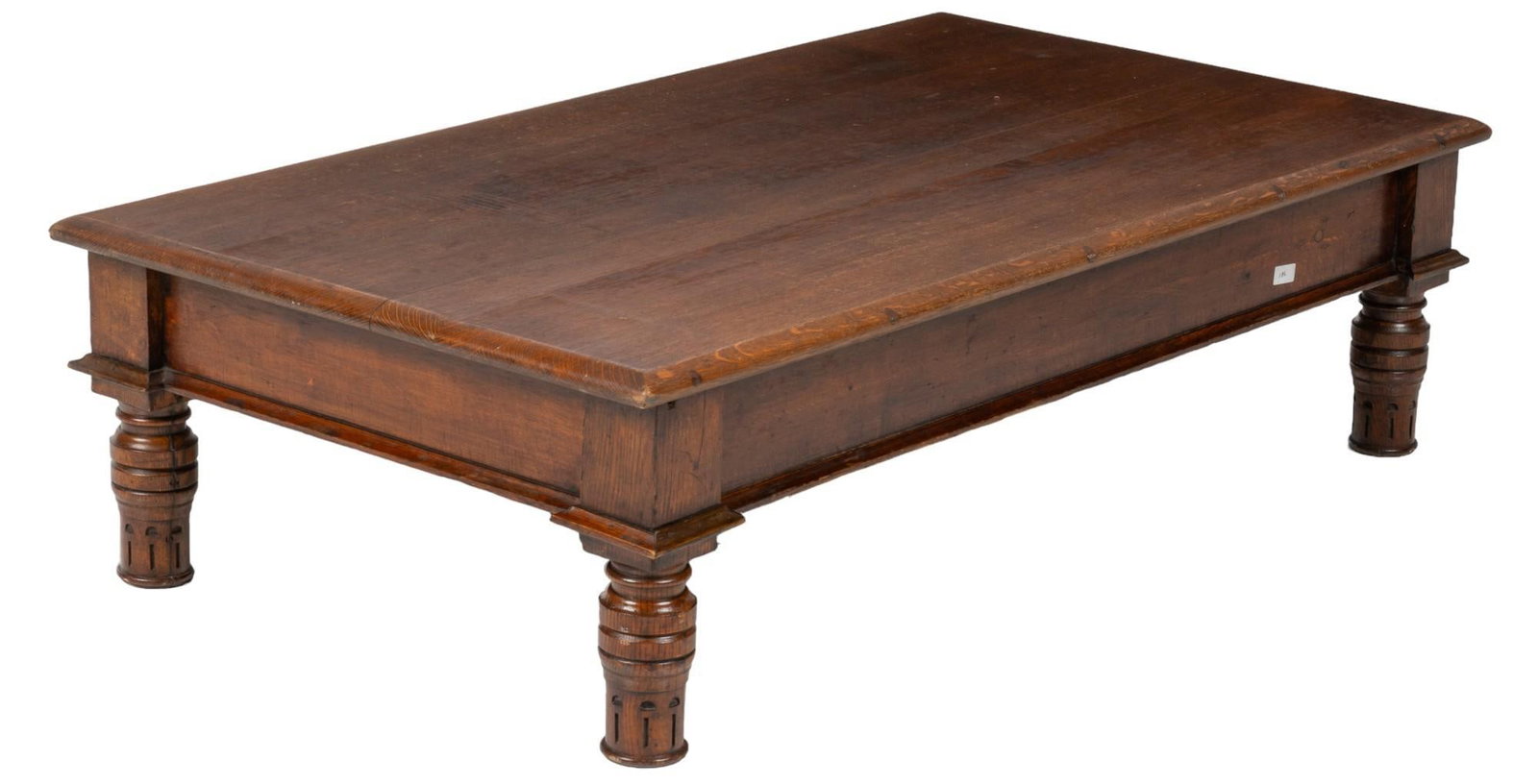 Coffee Table: Wooden coffee table with oversize top with beveled edge, and apron, supported on tooled legs height 14 in. x width 53 in. x depth 29 in. Shipping available for this lot through our partner 4CL; please