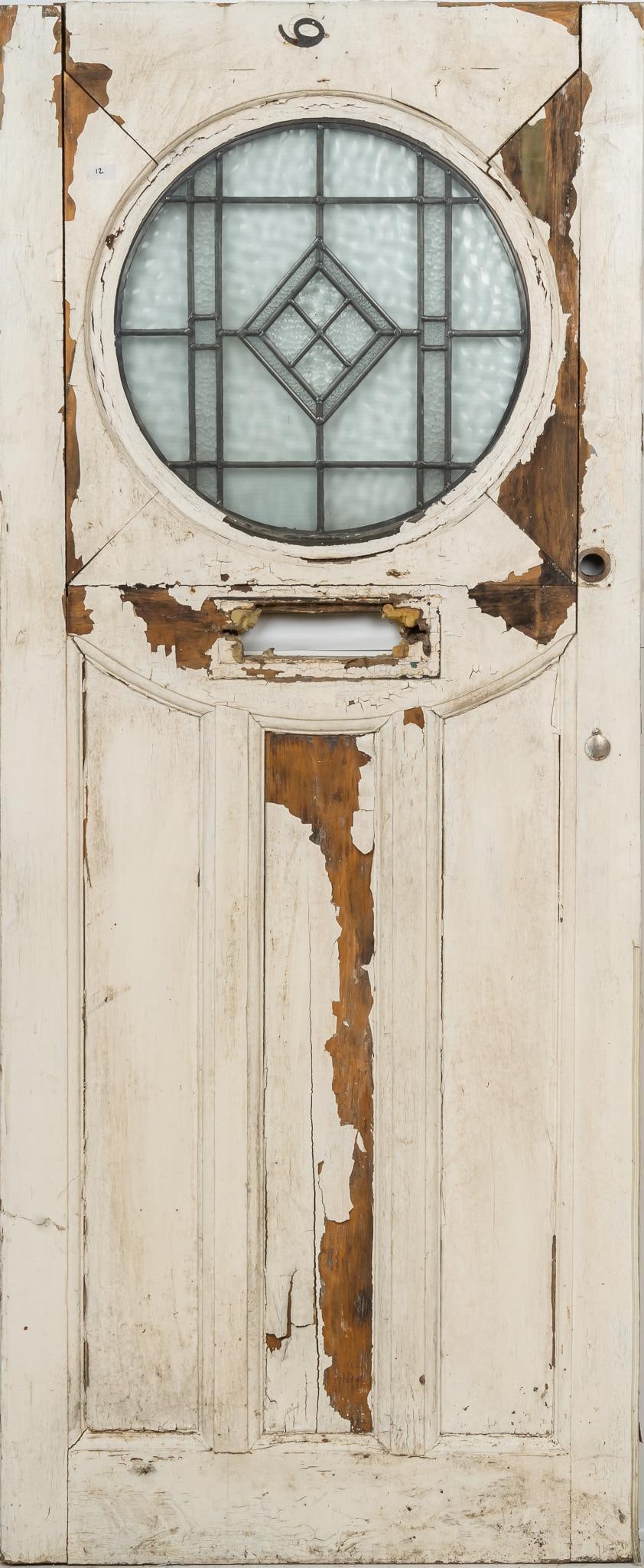 Stained Glass Door: Stained glass door with wooden frame, metal hardware, and white paint remnants height 78.5 in. x width 32 in. x depth 2 in. Shipping available for this lot through our partner 4CL; please request a sh