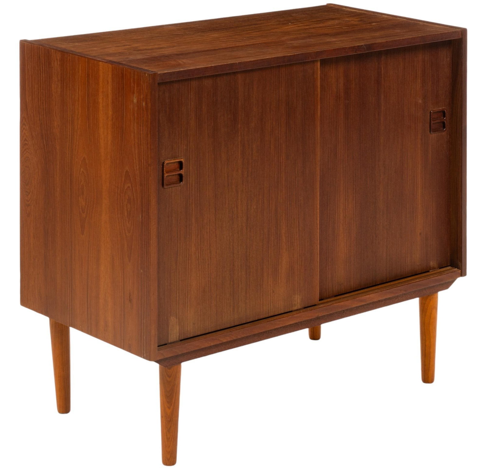 Danish Mid-Century Credenza: Danish mid-century credenza with pair of sliding doors with integrated wooden pulls, opening to interior storage with single shelf, supported on pin legs height 30 in. x width 35 in. x depth 11 in. Sh