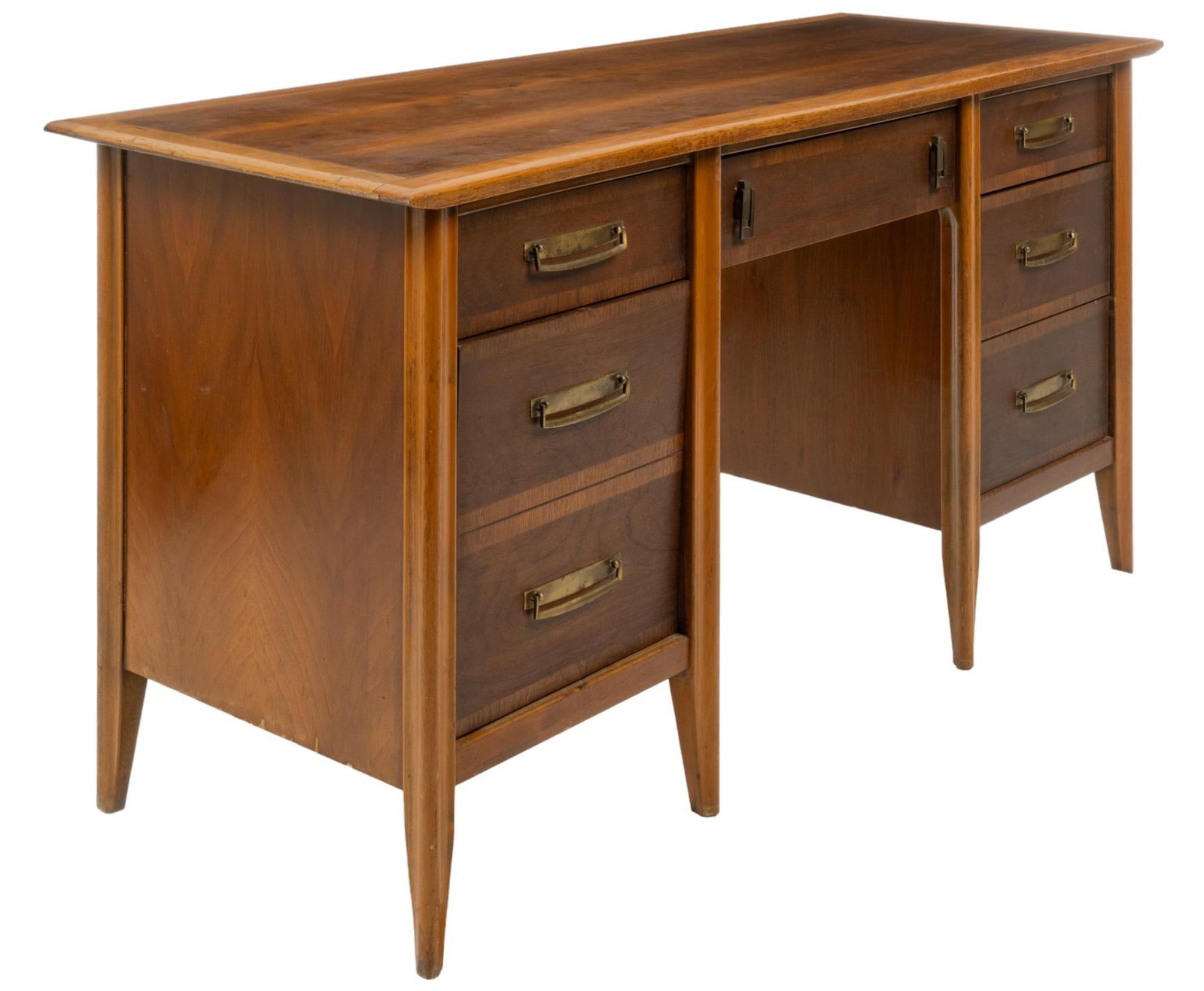 Stanley Furniture (USA) Mid-Century Desk: Stanley Furniture (USA) mid-century wooden desk featuring oversize top, middle drawer with twin metal pulls, flanked by stacks of three drawers with gold-toned metal pulls, supported on pin legs, mark